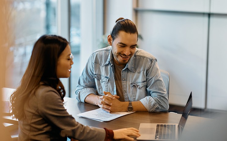 a small business owner discussing commercial real estate financing with a broker